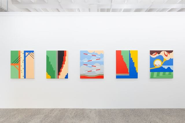 Five colourful, rectangular paintings hanging next to each other on a wall. 