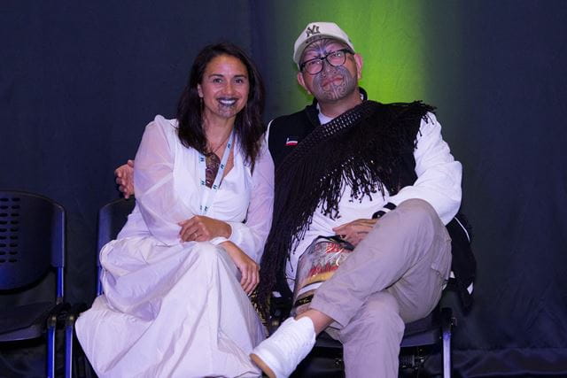 Cilla and Rob Ruha seated and smiling at the camera